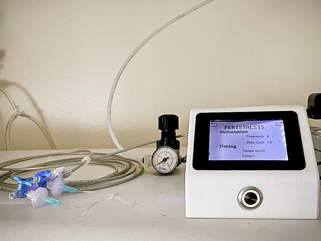 Photo of the gut-on-chip control system. The uBeat setup involves using compressed air and a pressure regulator to introduce mechanical stimulation on the microfluidic chip. A programmable controller allows the stimulation parameters and time of use to be set.