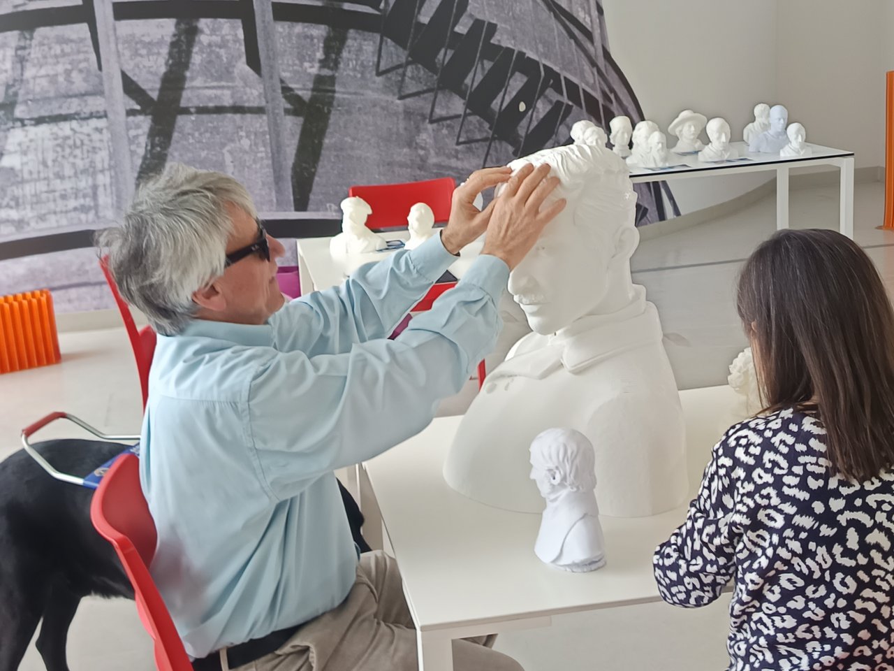 A visually impaired man explores a 3D-printed bust by touch, Plastic-IndexLab project, INDEXLAB Politecnico di Milano.