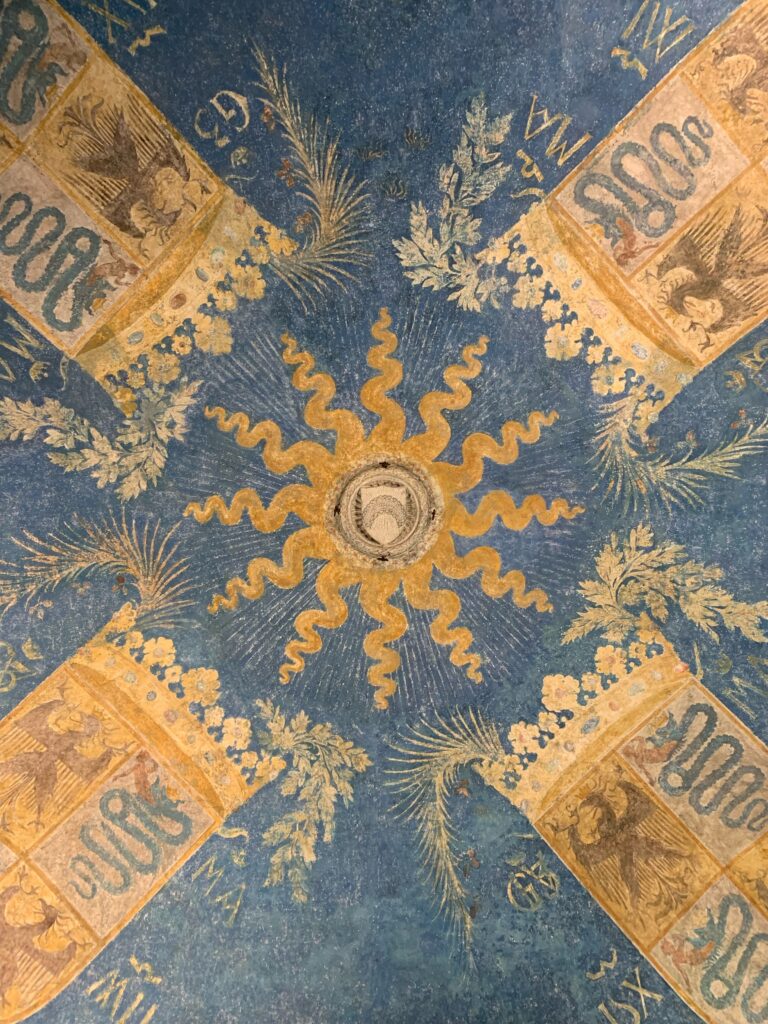 Image of a sun frescoed on the vaults of the Castello Sforzesco in Milan
